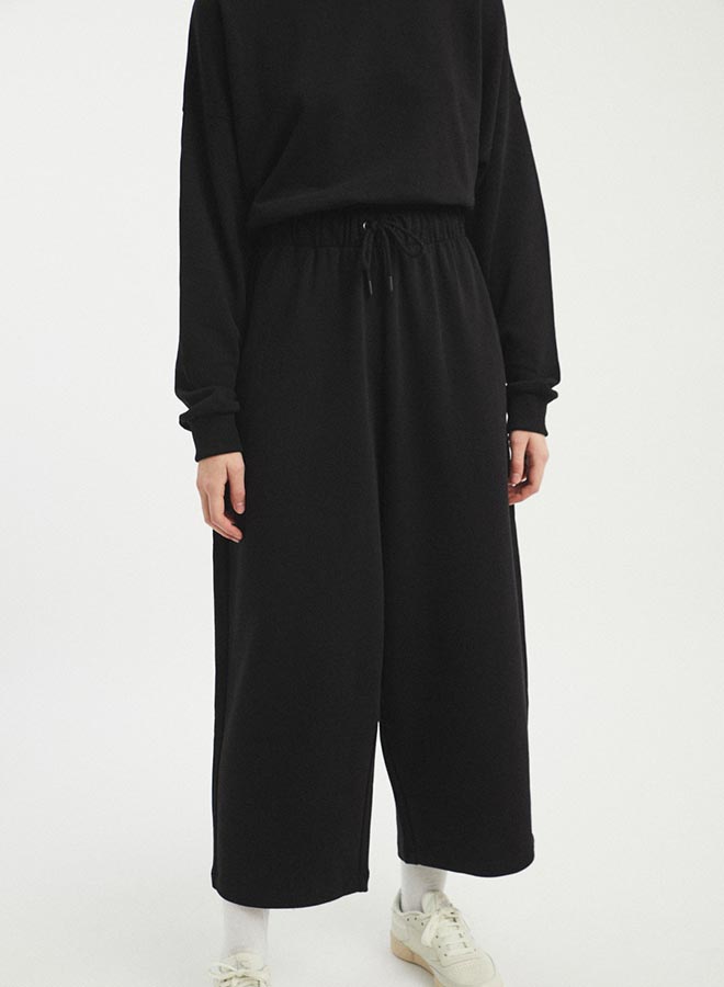 A wide leg loose fitting pant with an elastic tie waistband. The Wanda Pants in Black are designed by Rita Row and made in Girona, Spain.