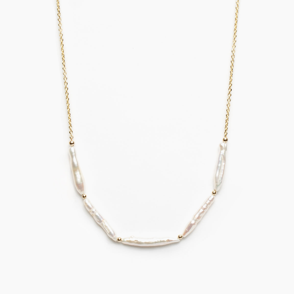 Gold necklace with five stick pearl beads on a white background