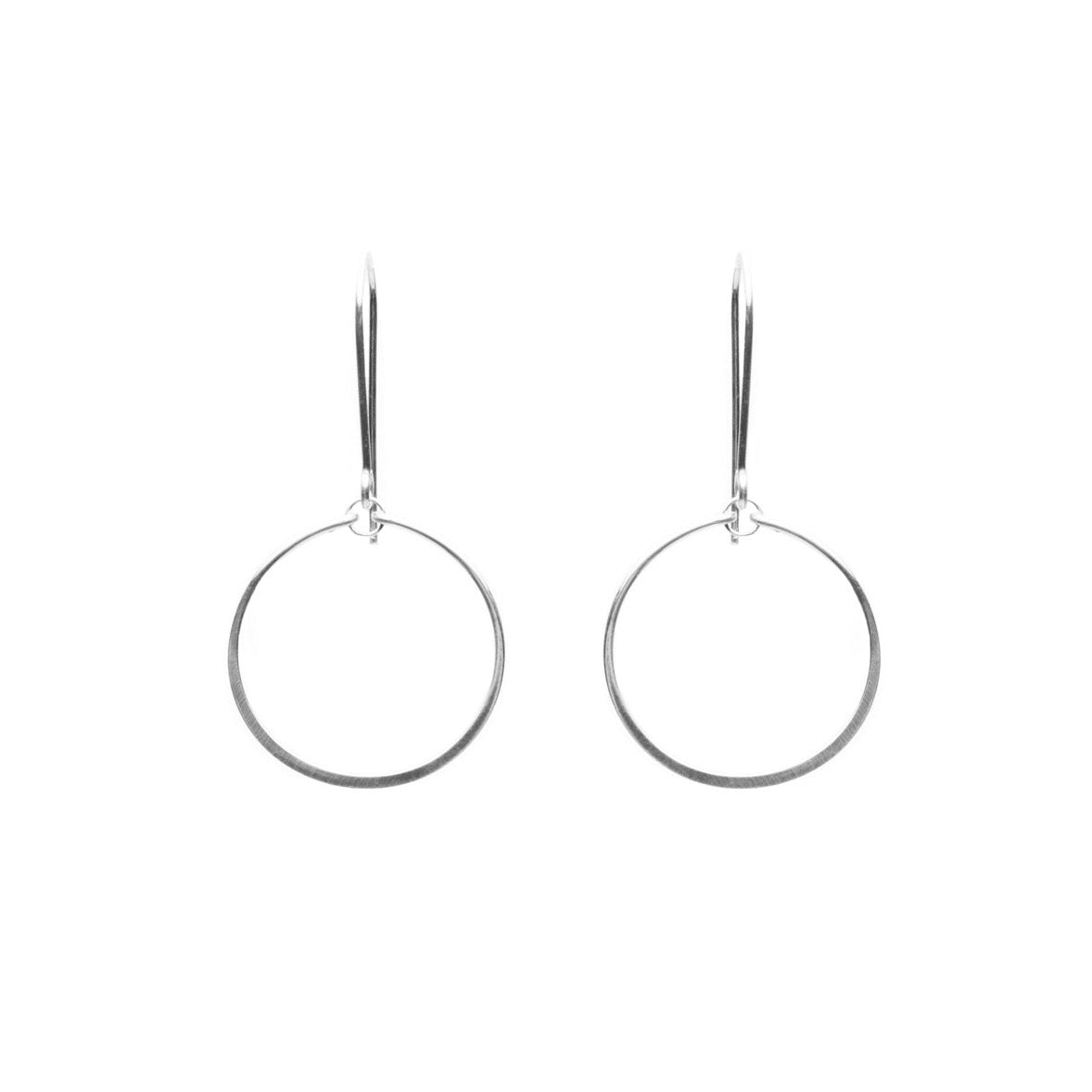 Delicate drop circle earrings formed out of sterling silver wire. Designed and handmade by Amy Olson in Portland, OR.