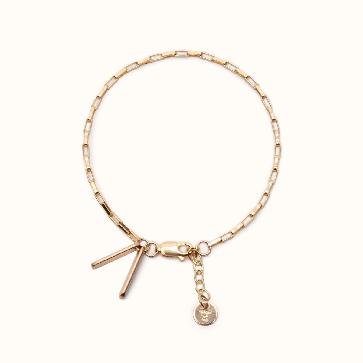 A delicate gold fill chain link bracelet with two petite rectangular tags, lobster clasp and jump rings to allow for adjustability. The Alba Bracelet is designed and handcrafted in Portland, Oregon.