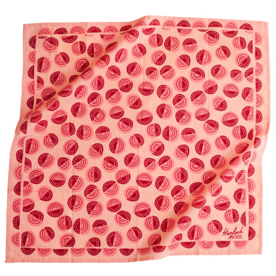 Pink bandana with pink and red circular pattern. Designed by Hemlock Goods in Fulton, MO and screen printed by hand in India.