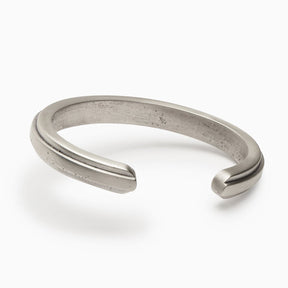 An interior view of a squared off solid sterling silver cuff with an exterior band of bronze running down the center. The Amanca Cuff is designed and handcrafted in Portland, Oregon.