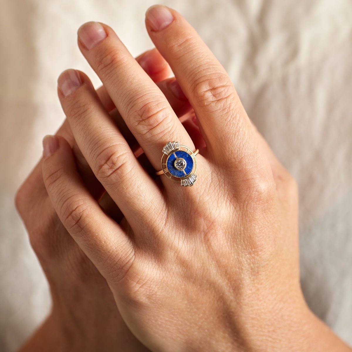 Model wears the Ara ring on their left hand. The Ara ring features lapis lazuli inlay and lab-grown diamonds.