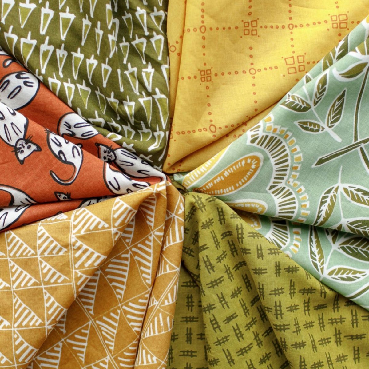 Image of an assortment of bandanas in various colors. Designed by Hemlock Goods in Fulton, MO and screen printed by hand in India.