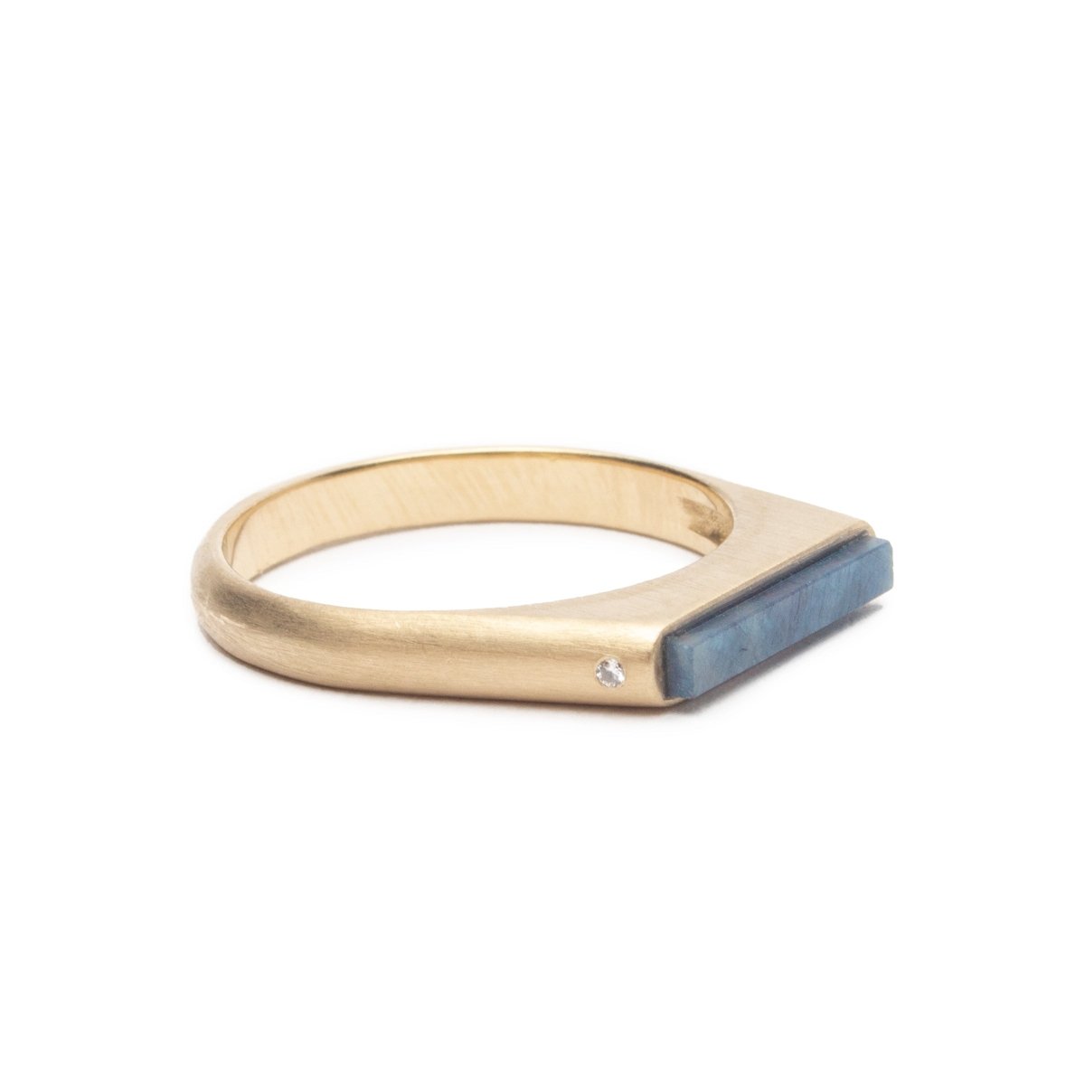 Sapphire Lucet ring with two white lab-grown diamonds, set in 14k recycled yellow gold. Designed and handcrafted in Portland, Oregon.