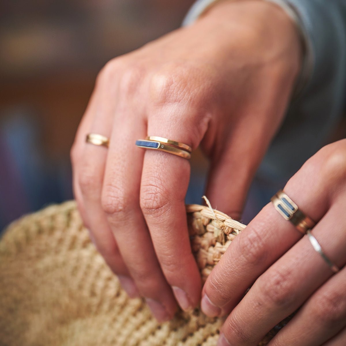 Sapphire Lucet ring with two white lab-grown diamonds, set in 14k recycled yellow gold. Designed and handcrafted in Portland, Oregon.