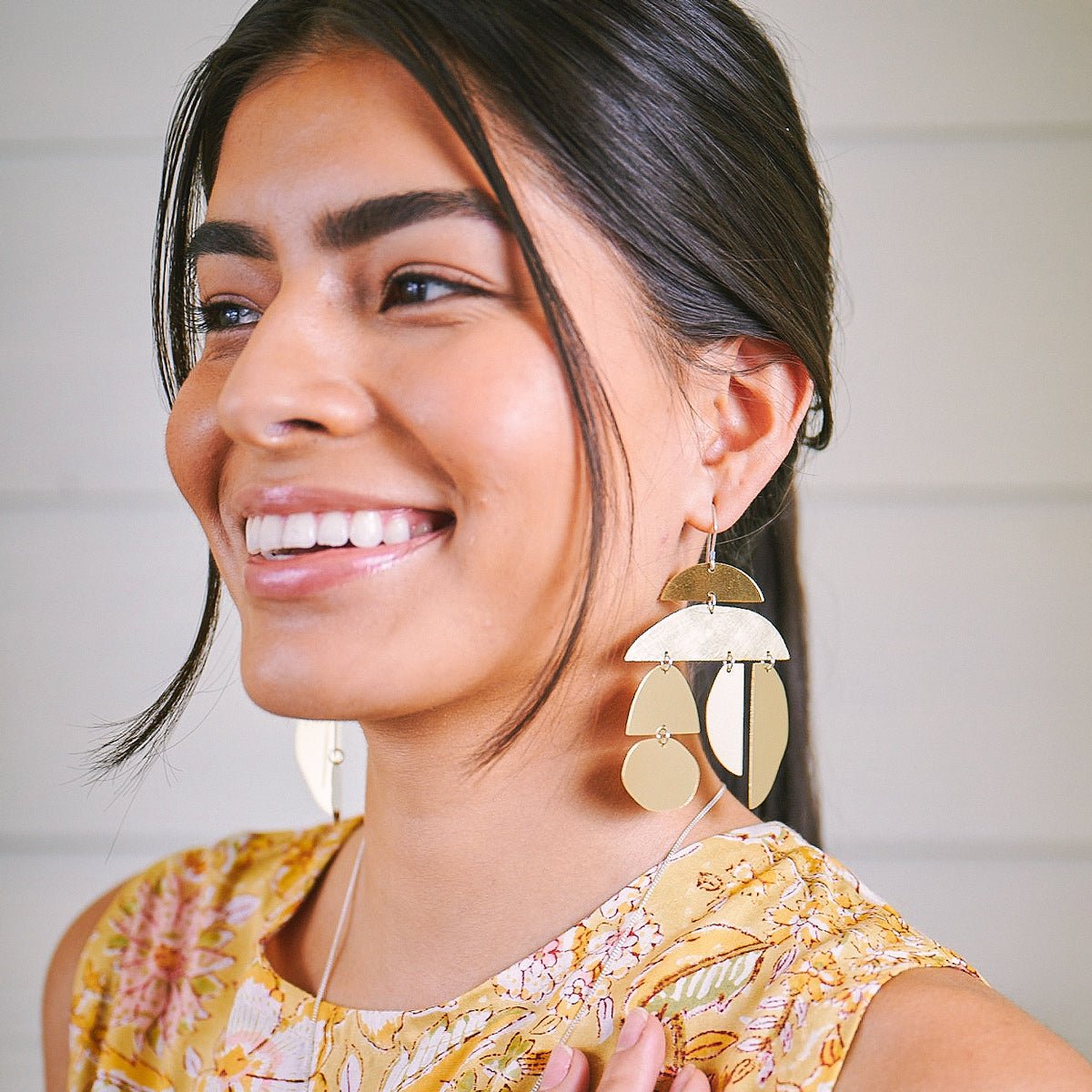 Onda earrings in brush-finished and polished brass. Designed and handcrafted in Portland, Oregon.