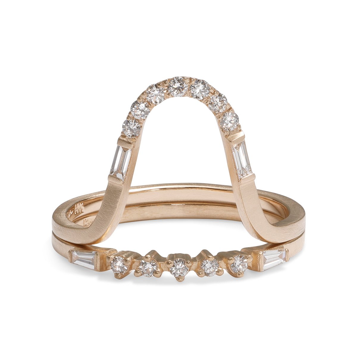 The Levo ring stacked on top of the Alma ring. Both feature baguette and brilliant cut round lab-grown diamonds in 14K gold.