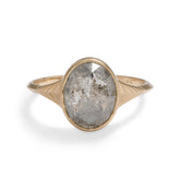 Modern oval Nubis ring with a salt & pepper diamond. 14K gold band features geometric engravings.
