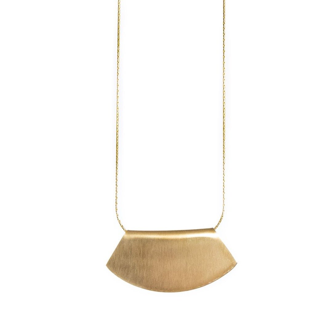 Delicate 14k gold-filled chain threaded through a fan-shaped 14k gold-filled pendant, engraved on one side with the betsy & iya logo. Hand-crafted in Portland, Oregon.
