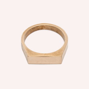  A narrow signet ring with a polished rectangular top and hammered detail on the band. Made in bronze. Designed and handcrafted in Portland, Oregon.