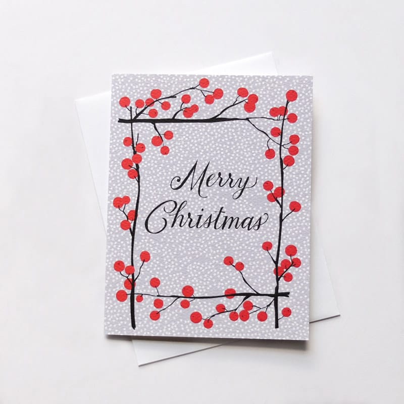 Front of card reads: "MERRY CHRISTMAS" in calligraphy font framed by red winter berries. Made with recycled paper by Banquet Atelier in Vancouver, British Columbia, Canada.