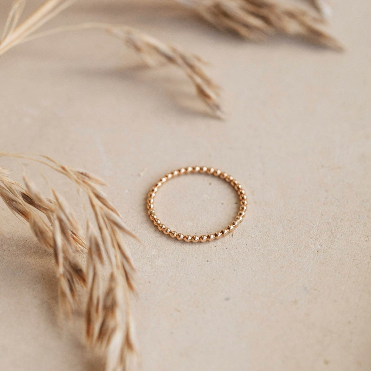 A dainty beaded gold tone ring. The beaded ring is handcrafted by Hello Adorn in Eau Claire, WI.