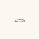 A dainty beaded gold tone ring. The beaded ring is handcrafted by Hello Adorn in Eau Claire, WI.