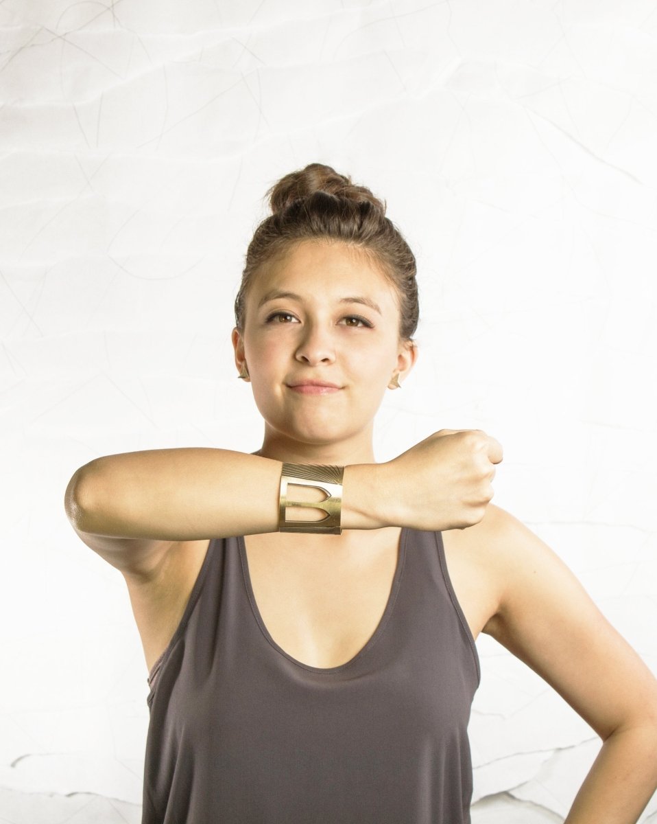 The betsy & iya Brooklyn Bridge cuff bracelet worn proudly by a model.