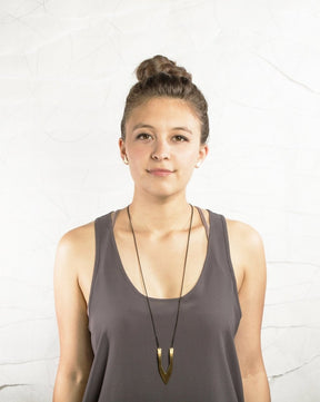 The gold-toned simple Cathedral Park necklace is featured on a model here to show length.