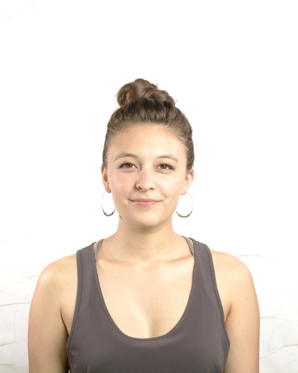 Simple silver hoop earrings shown on model.