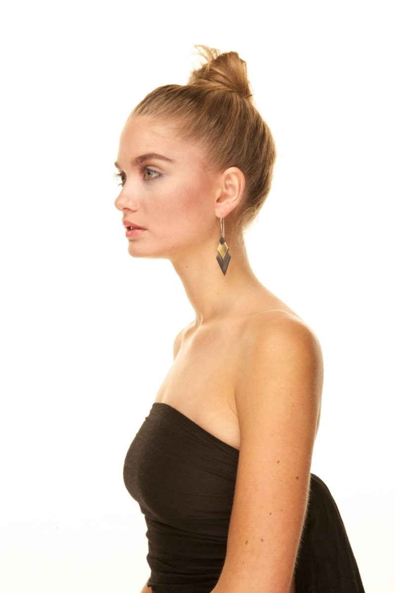 Model wearing betsy & iya dangling chevron earrings.