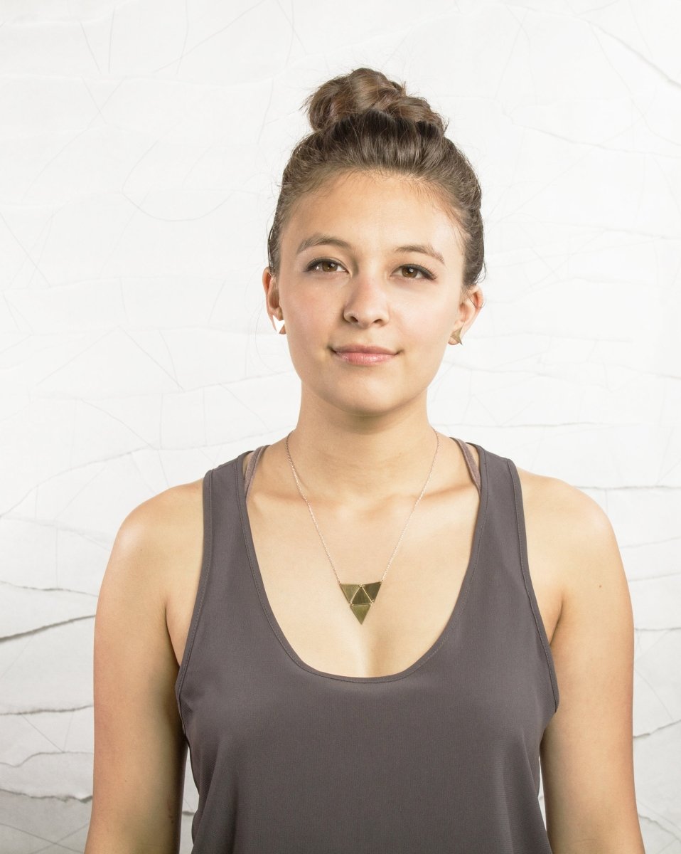 The geometric sandstorm necklace by betsy & iya is worn by a model to show scale.