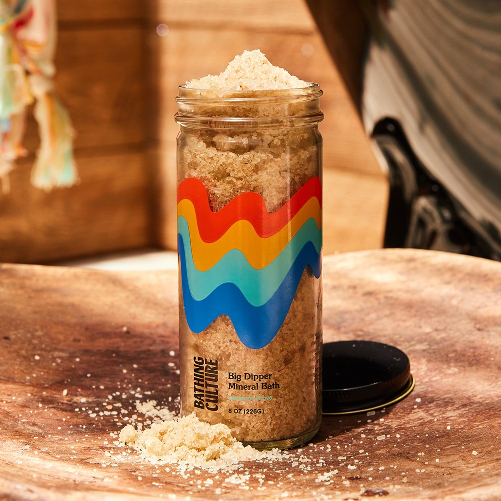 A clear glass jar holds a mineral bath soak. The Big Dipper Mineral Bath is handcrafted by Bathing Culture in San Francisco, California.