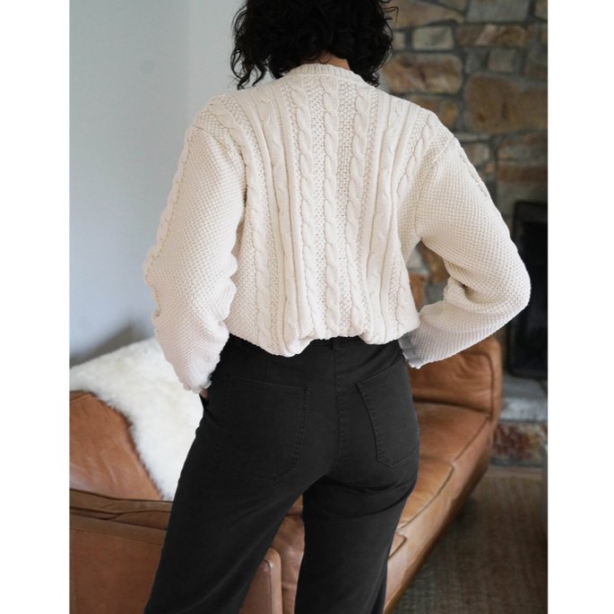 Model shows the back side of a straight leg cropped work pant in black. The James Pant in Black is designed by Loup and made in New York City, USA.
