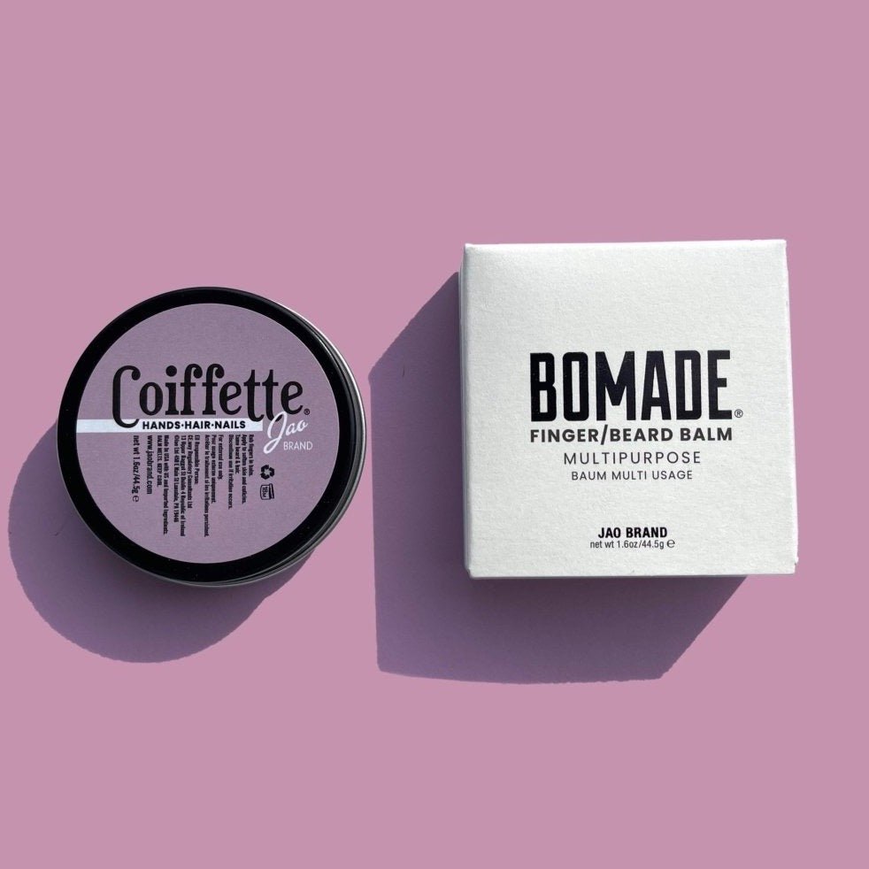 A round tin filled with multipurpose balm against a purple background. Bomade: Coiffette is designed and made by Jao Brand in Pennsylvania, USA.