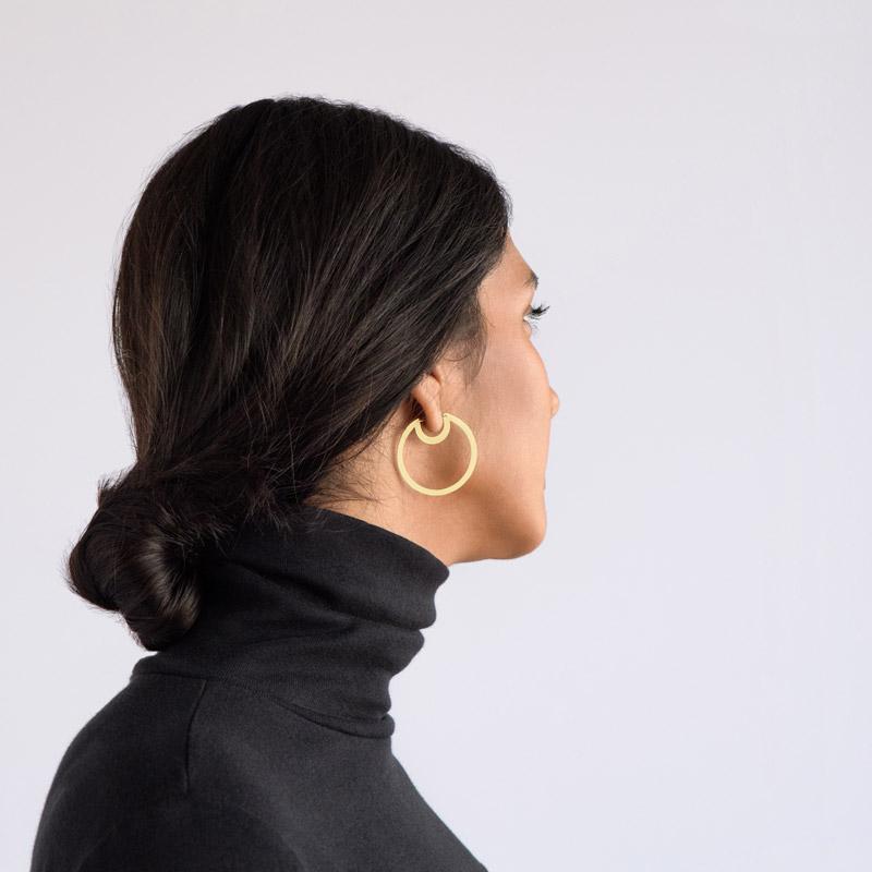 Bombona Small Hoop Earrings in brass on model