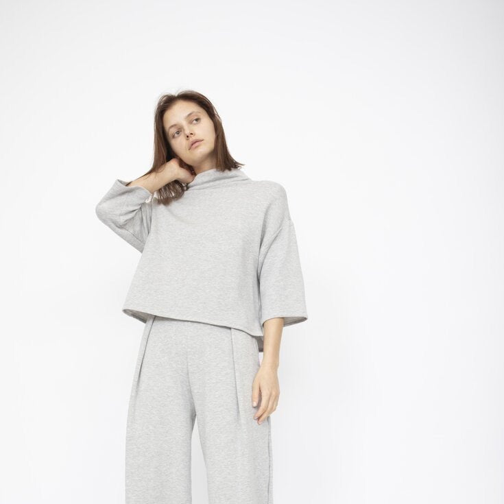 Loose fitting top with 3/4 sleeve and draped neck. The Bucket Sweater in Heather Grey is designed by Corinne and made in Los Angeles, CA.