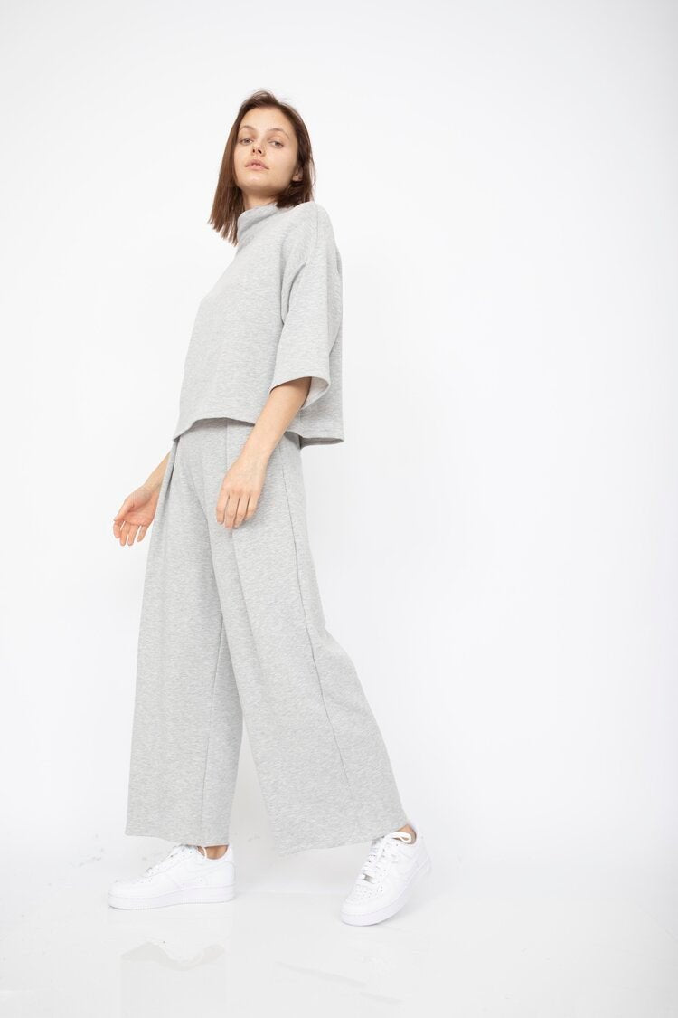 Loose fitting top with 3/4 sleeve and draped neck. The Bucket Sweater in Heather Grey is designed by Corinne and made in Los Angeles, CA.