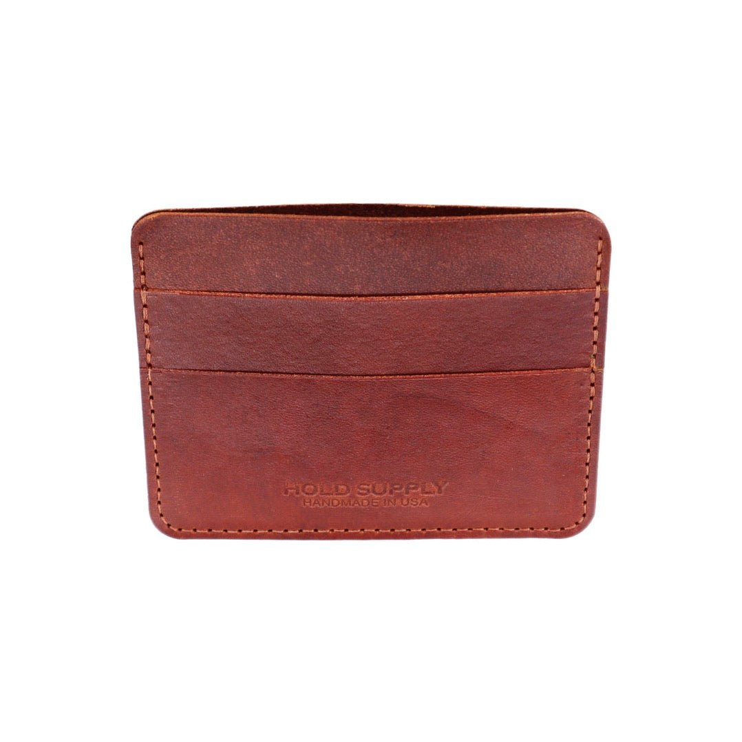 A narrow wallet sized card holder with multiple compartments. The Card Holder Wallet in Brown is designed and handcrafted by Hold Supply in Anaheim, California.