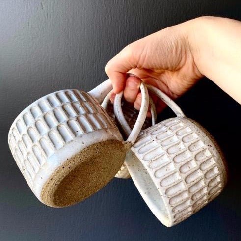 Wheel thrown hand carved mug with speckled glossy white finish. Handmade by Amy A ceramics in Portland, Oregon.