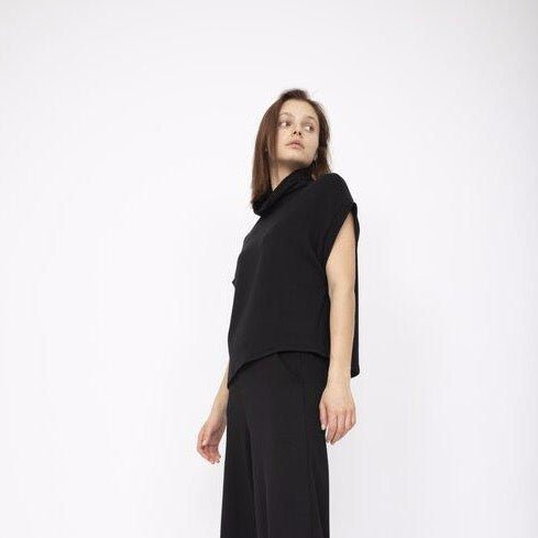 A draped short sleeve top with a slouchy mock neck in Black. Fabric and top made in Los Angeles, CA by Corinne Collection.