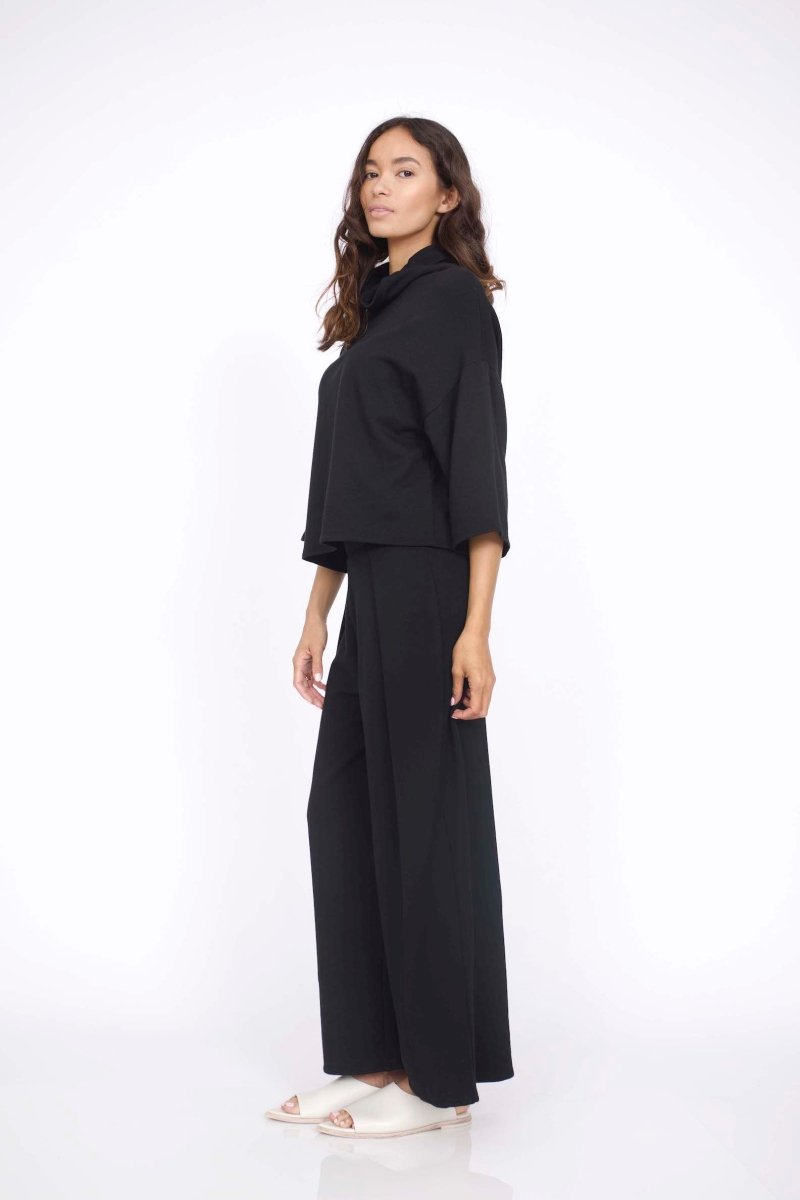 Loose fitting top with 3/4 sleeve and draped neck. The Bucket Sweater in Black is designed by Corinne and made in Los Angeles, CA.