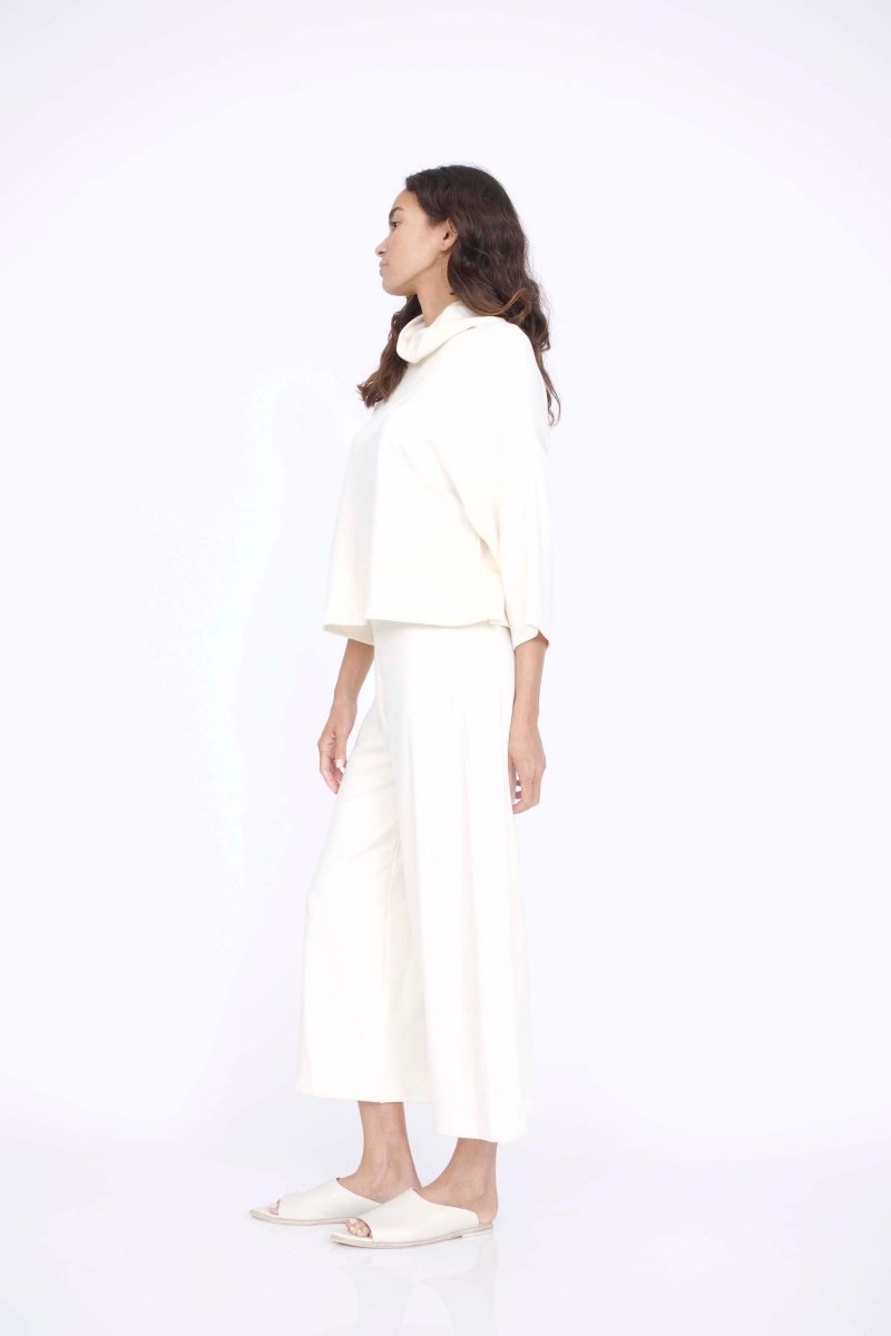 Loose fitting top with 3/4 sleeve and draped neck. The Bucket Sweater in Ivory is designed by Corinne and made in Los Angeles, CA.