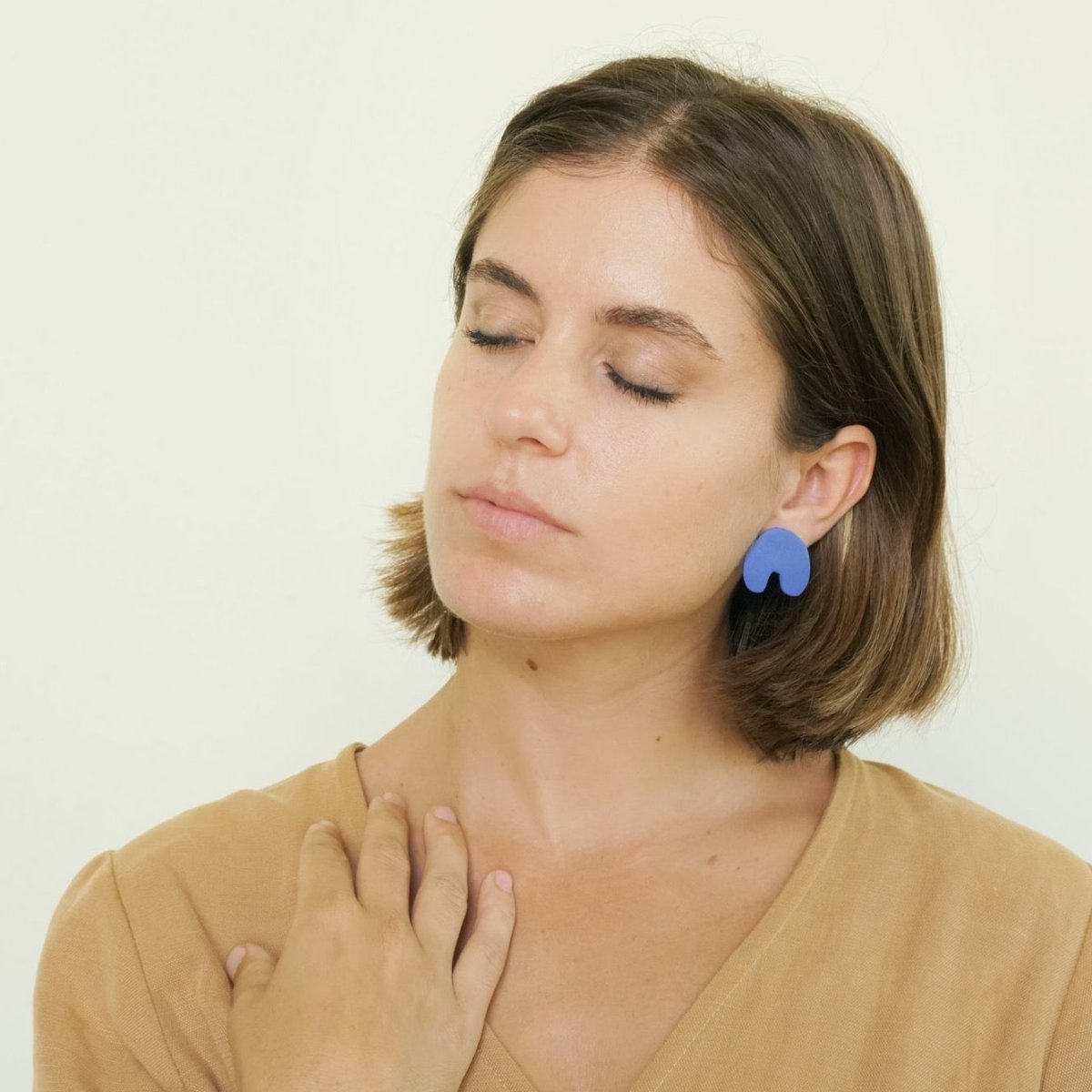Arch shaped stud earrings made of polymer clay in the shade Classic Blue. Made in Los Angeles, California by Hey Moon Designs.