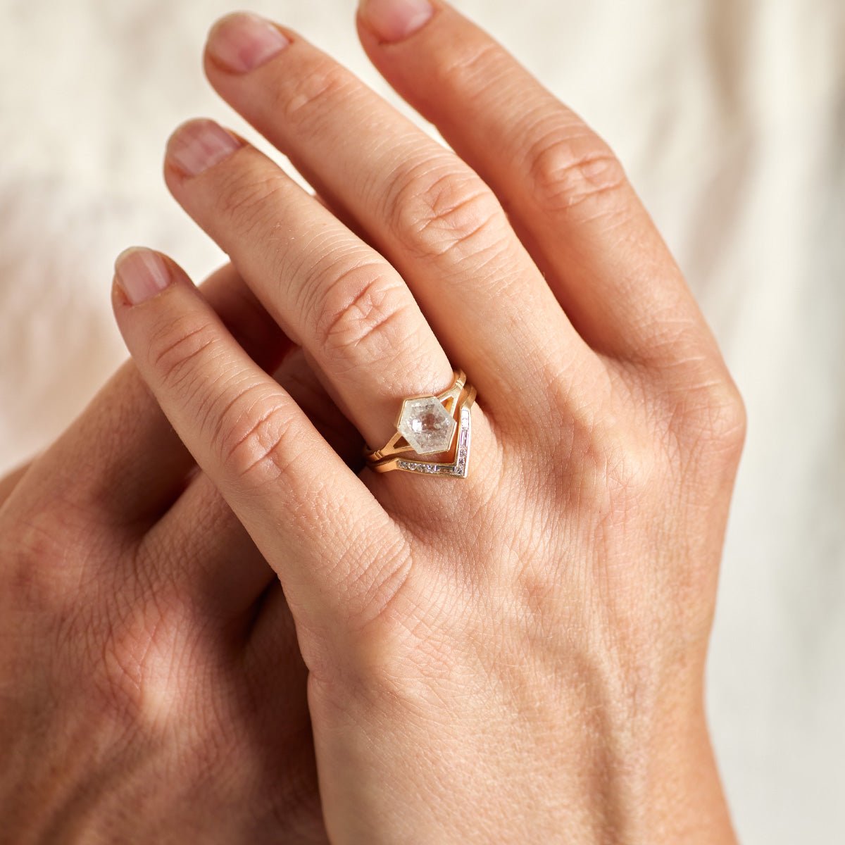 Model wears the Dea ring stacked on top of the Altus ring.