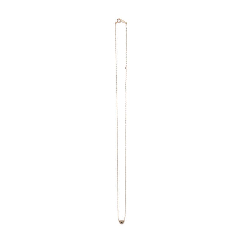 Tiny, half-moon pendant of 14k yellow gold, inlaid with a black diamond, and affixed to a delicate gold chain with spring-ring clasp. Hand-crafted in Portland, Oregon.