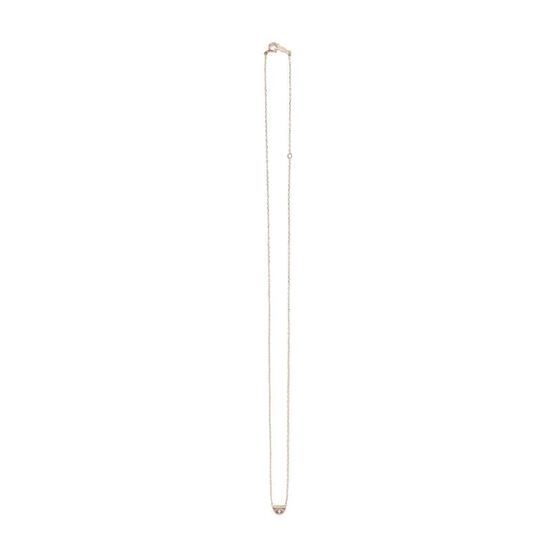 Tiny, half-moon pendant of 14k yellow gold, inlaid with a white diamond, and affixed to a delicate gold chain with spring-ring clasp. Hand-crafted in Portland, Oregon.