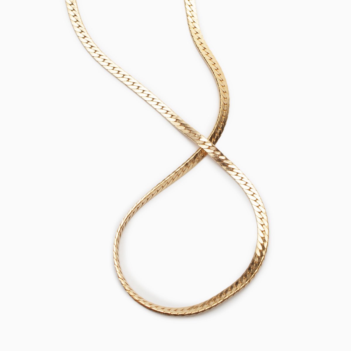 A classic gold tone herringbone necklace. The Bold Herra Necklace is handcrafted by Hello Adorn in Eau Claire, WI.