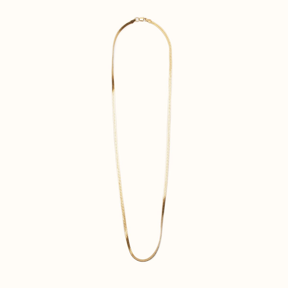 A classic gold tone herringbone necklace. The Bold Herra Necklace is handcrafted by Hello Adorn in Eau Claire, WI.