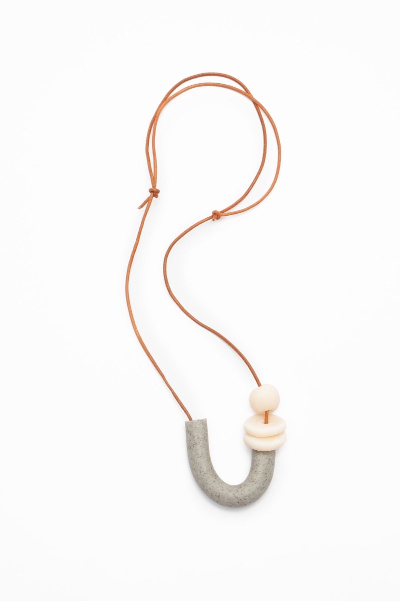 U shaped necklace made of polymer clay and orange leather cord. Made in Los Angeles, California by Hey Moon Designs.