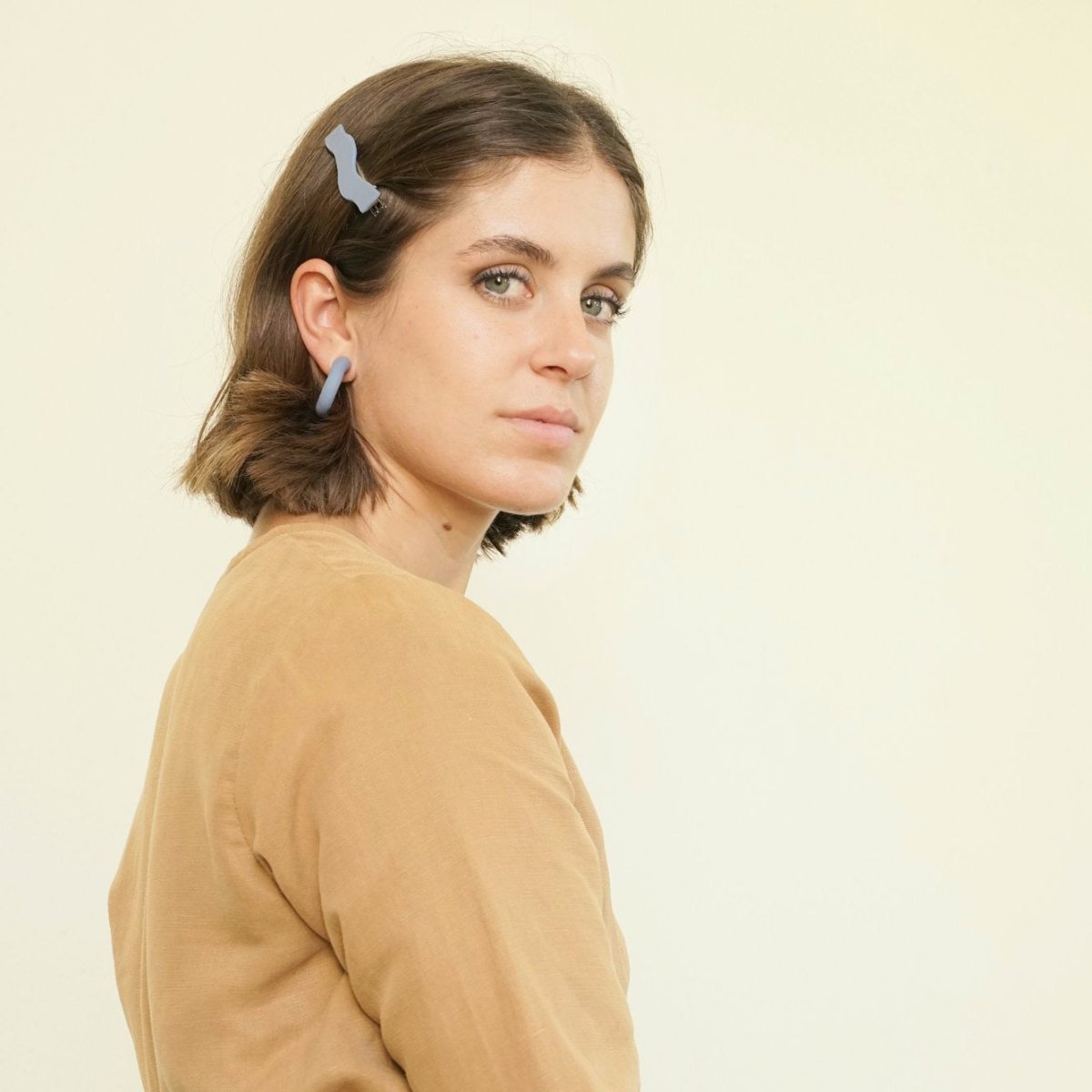 Wave shaped hair clip in the shade Sky. Displayed on a model with light brown hair. Made in Los Angeles, California by Hey Moon Designs.