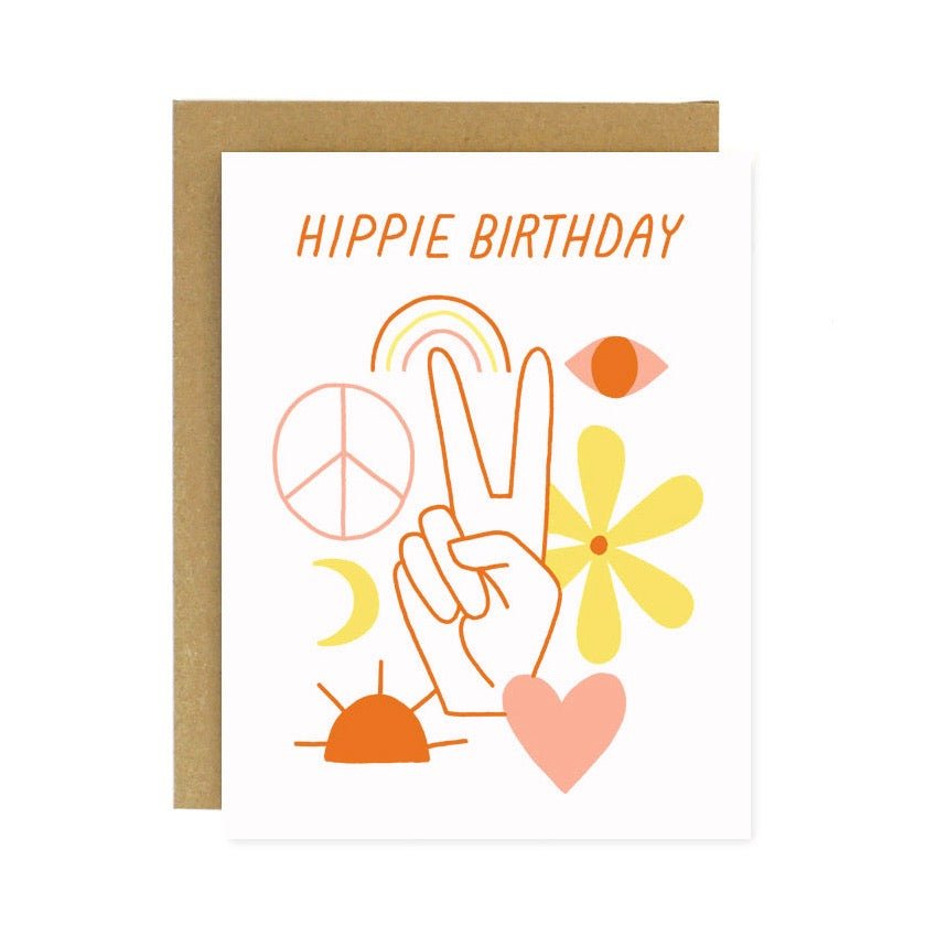 A white card with a yellow, pink, orange and red peaceful illustrations. An image of a hand hols up a peace sign. Front of card reads: "HIPPIE BIRTHDAY." Designed and handcrafted by Worthwhile Paper in Ypsilanti, MI.