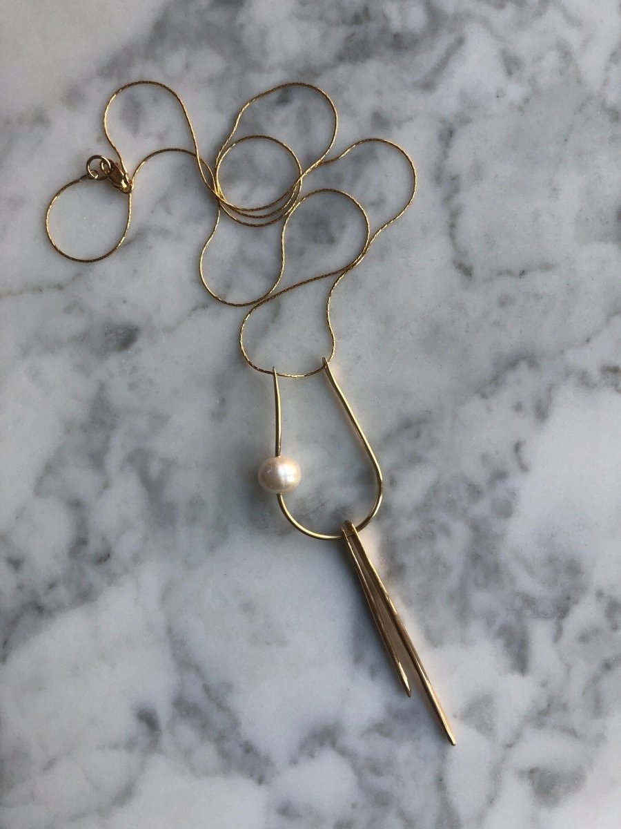 Kari Phillips Pearl and Talon Necklace. Freshwater pearl and forged brass components. 22” 14k gold filled chain and lobster claw clasp.