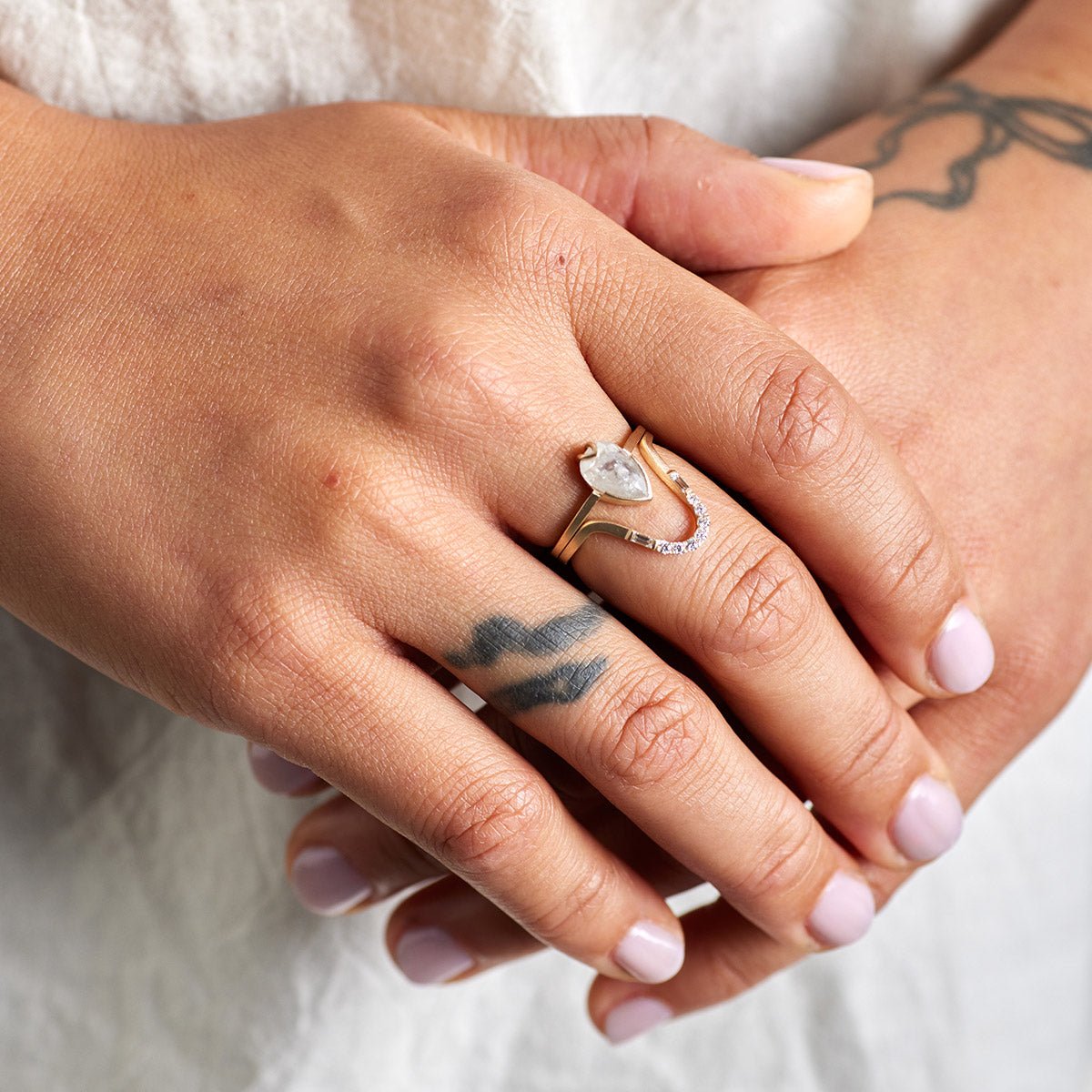 Model wears the Levo and Ignis rings.