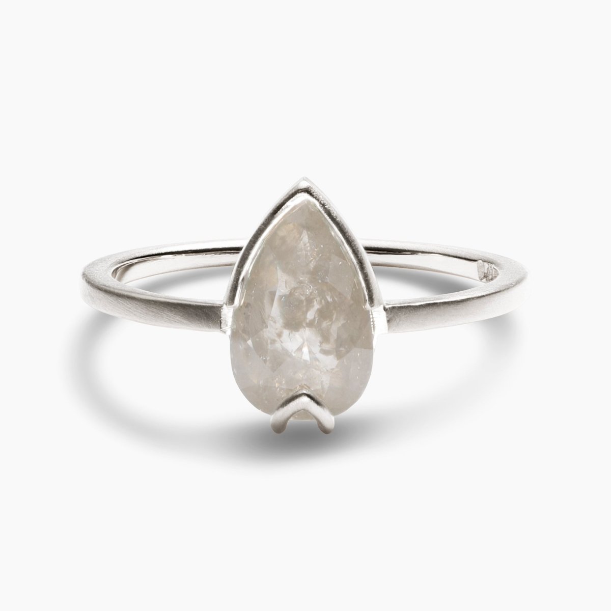 Pear-shaped Ignis ring. Features a salt & pepper diamond set in recycled 14K white gold. All stones and materials are conflict free.