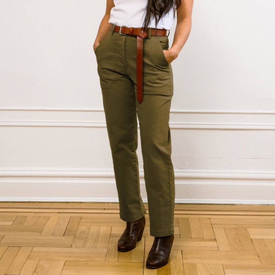 Model wears a straight leg cropped work pant in an army green. The James Pant in Moss Green is designed by Loup and made in New York City, USA.