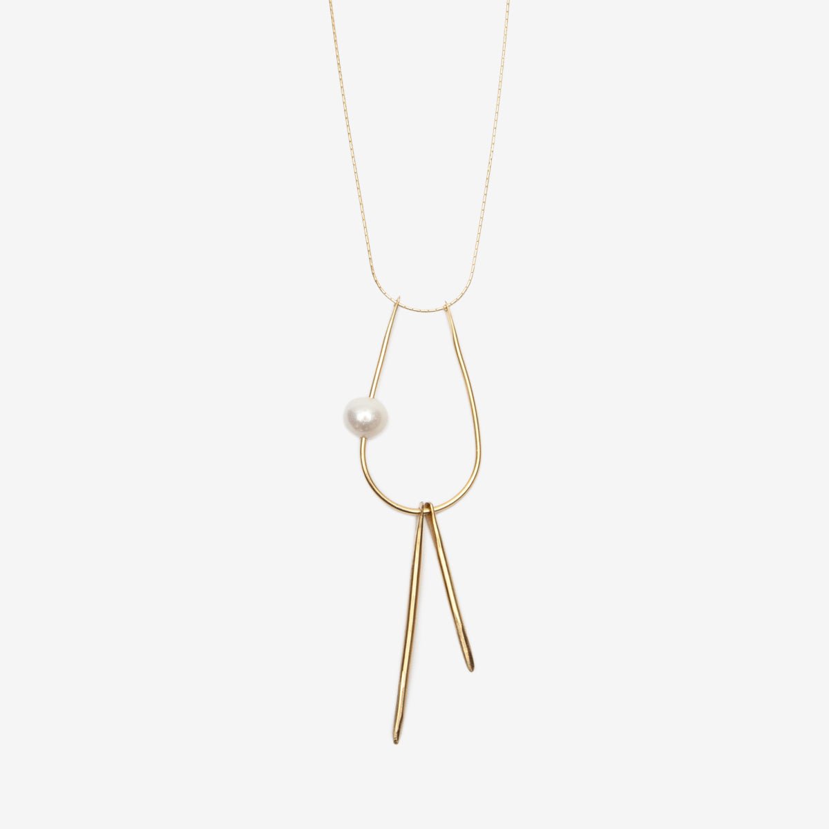 Kari Phillips Pearl and Talon Necklace. Freshwater pearl and forged brass components. 22” 14k gold filled chain and lobster claw clasp.
