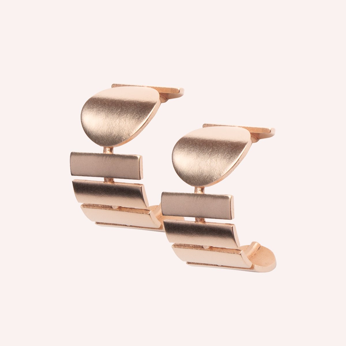 A wide bronze hoop earring featuring a circular and rectangular pattern. Designed and handcrafted in Portland, Oregon.