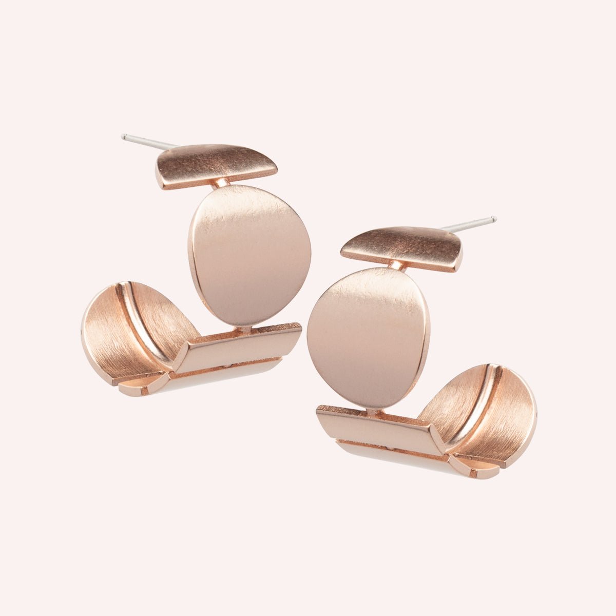 A wide bronze hoop earring featuring a circular and rectangular pattern. Designed and handcrafted in Portland, Oregon.
